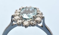 Lot 945 - An aquamarine and diamond cluster ring, the...