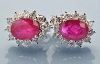 Lot 946 - A pair of ruby and diamond cluster earrings,...