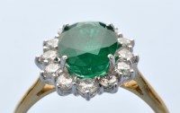 Lot 947 - An emerald and diamond and cluster ring, the...