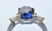 Lot 948 - A sapphire and diamond ring, the oval facet...