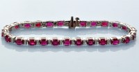 Lot 949 - A ruby and diamond line bracelet, the twenty...