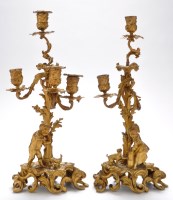 Lot 1036 - A pair of gilt bronze candelabra, one with...