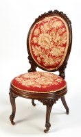 Lot 1341 - A Victorian carved rosewood nursing chair, the...
