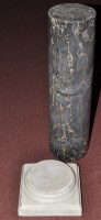 Lot 1355 - A black marble cylindrical column, with orange...