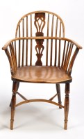 Lot 1374 - A 19th Century elm seat Windsor armchair, the...