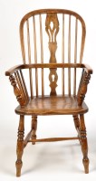 Lot 1375 - A 19th Century elm seat Windsor arm chair, the...