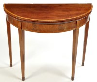 Lot 1390 - A George III mahogany demi lune turnover top...