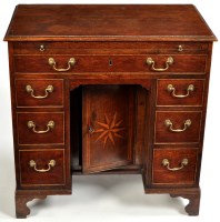 Lot 1395 - A Georgian oak kneehole desk, the rectangular...