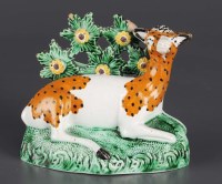 Lot 305 - A Staffordshire figure of a hind at lodge,...