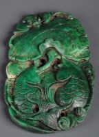 Lot 477 - A green stone pendant, carved as two carp with...