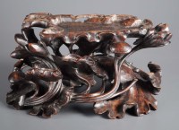 Lot 479 - A large hardwood stand, carved with lotus...