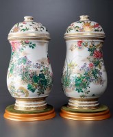 Lot 491 - A pair of baluster form covered vases, painted...