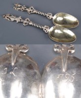 Lot 664 - A pair of white metal 'marriage' spoons, with...