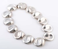 Lot 814 - A Mexican silver bracelet, the circular disk...