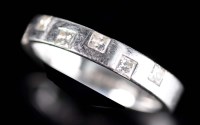 Lot 821 - A diamond and platinum band, the plain band...