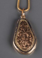 Lot 823 - A locket of shaped outline, front engraved...