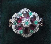 Lot 826 - A ruby and diamond cluster ring in a...