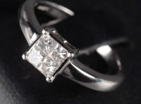 Lot 831 - A four stone diamond ring, the four brilliant...