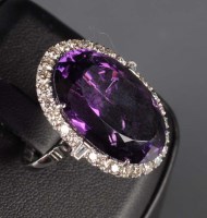 Lot 849 - An amethyst and diamond ring, the oval mixed...