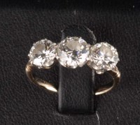 Lot 850 - A three stone diamond ring, the three...