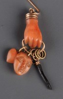 Lot 851 - A coral tie pin, c.1880, the carved coral hand...