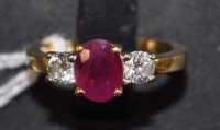 Lot 855 - A ruby and diamond three-stone ring, on gold...