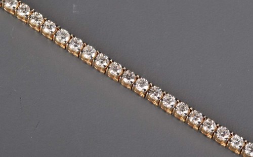 Lot 862 - A diamond line bracelet, the thirty-eight...
