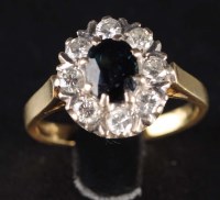 Lot 875 - A sapphire and diamond cluster ring, the oval...