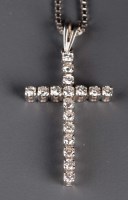 Lot 880 - A diamond pendant modelled as a cross, set...