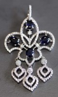 Lot 884 - A sapphire and diamond pendant, the four oval...