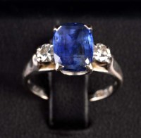 Lot 892 - A sapphire and diamond three stone ring, the...