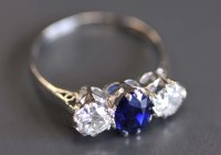 Lot 899 - A sapphire and diamond ring, the oval...