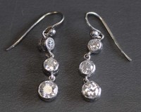 Lot 902 - A pair of Edwardian diamond earrings, each...