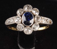 Lot 915 - A sapphire and diamond cluster ring, circa...