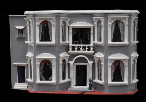 Lot 994 - A painted wooden dolls house, the brake front...