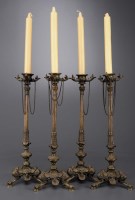 Lot 1030 - A set of four 20th Century bronze candlesticks,...