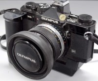 Lot 1113 - An Olympus OM-2n camera (black), fitted 50mm...