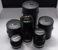 Lot 1115 - An Olympus Zuiko 28mm f3.5 lens; a Zuiko 135mm...