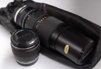 Lot 1122 - An Olympus Zuiko 85-250mm f5 zoom lens; and an...