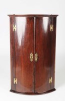 Lot 1333 - A George III mahogany bowfront hanging corner...