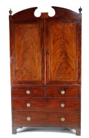 Lot 1360 - A late Georgian mahogany linen press with a...