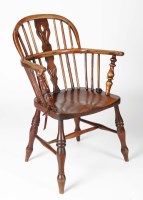 Lot 1408 - An early 19th Century Windsor elm armchair,...