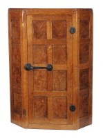 Lot 1424 - A Mouseman oak hanging corner cupboard, with...