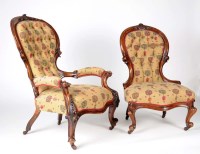 Lot 1446 - A Victorian walnut open armchair, with carved...