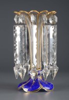 Lot 198 - A glass lustre: the gilded clear glass vase...