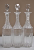 Lot 204 - Three cut glass decanters of faceted form,...