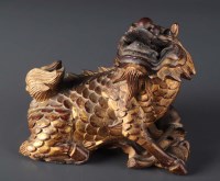 Lot 352 - A carved giltwood lion dog, originally part of...