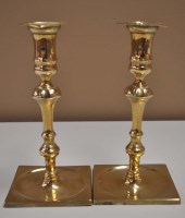 Lot 516 - A pair of 19th Century brass candlesticks, the...