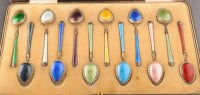 Lot 621 - Twelve vari coloured silver gilt and enamel...