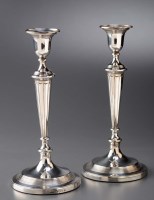 Lot 658 - A pair of George III candlesticks, by John...